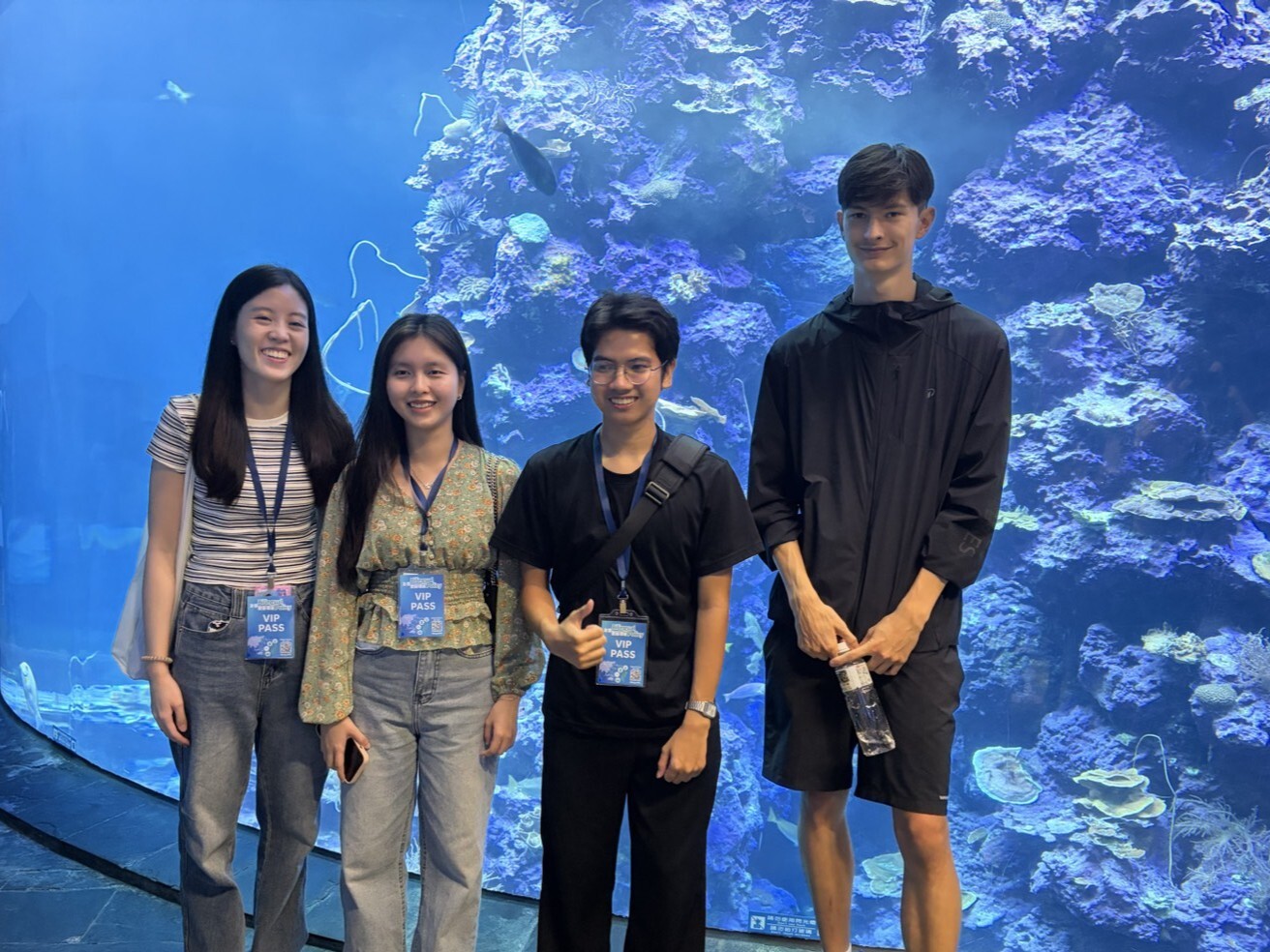 International students visiting an aquarium exhibit